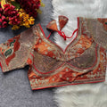 Decorative blouse with intricate patterns on a textured surface with flowers.