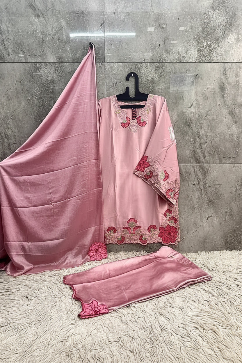 Pink embroidered outfit with dupatta on a gray background
