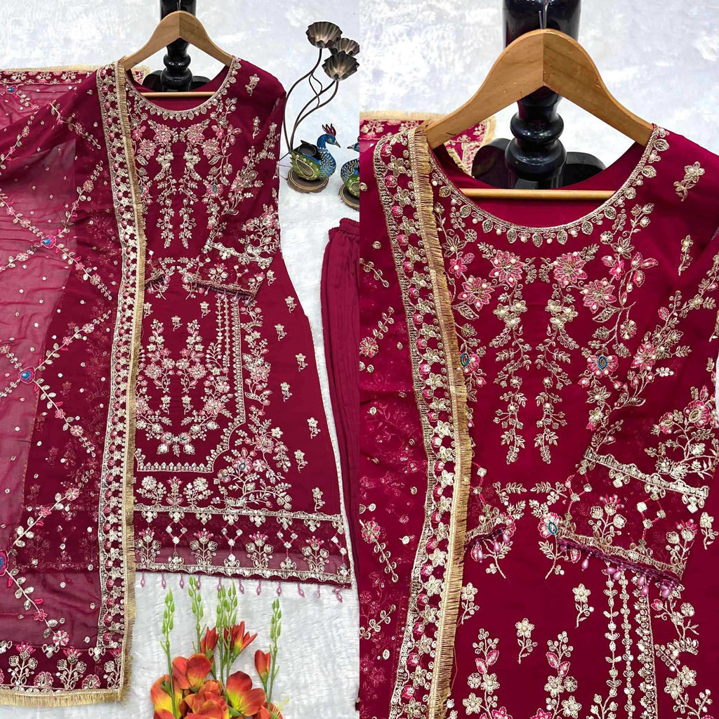 Maroon embroidered traditional outfit on a white background