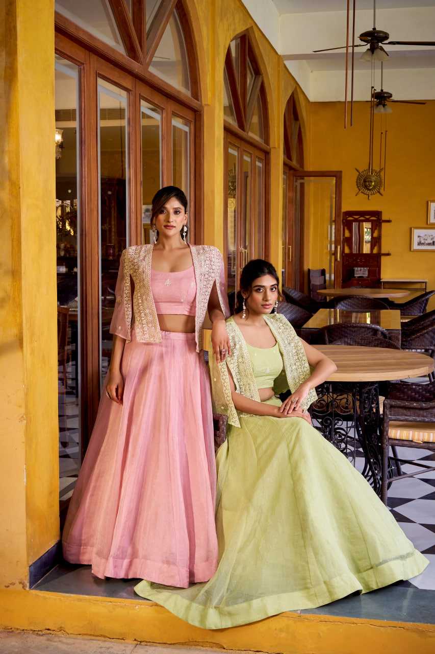 Two women in traditional outfits standing in a cafe with yellow walls and wooden furniture.