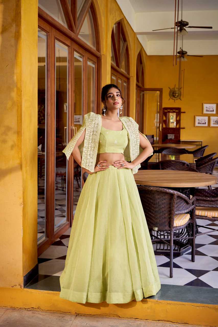Woman in a light green traditional outfit standing in a restaurant with yellow walls and black and white checkered floor.