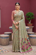 Woman in a traditional saree with floral patterns in a decorative setting