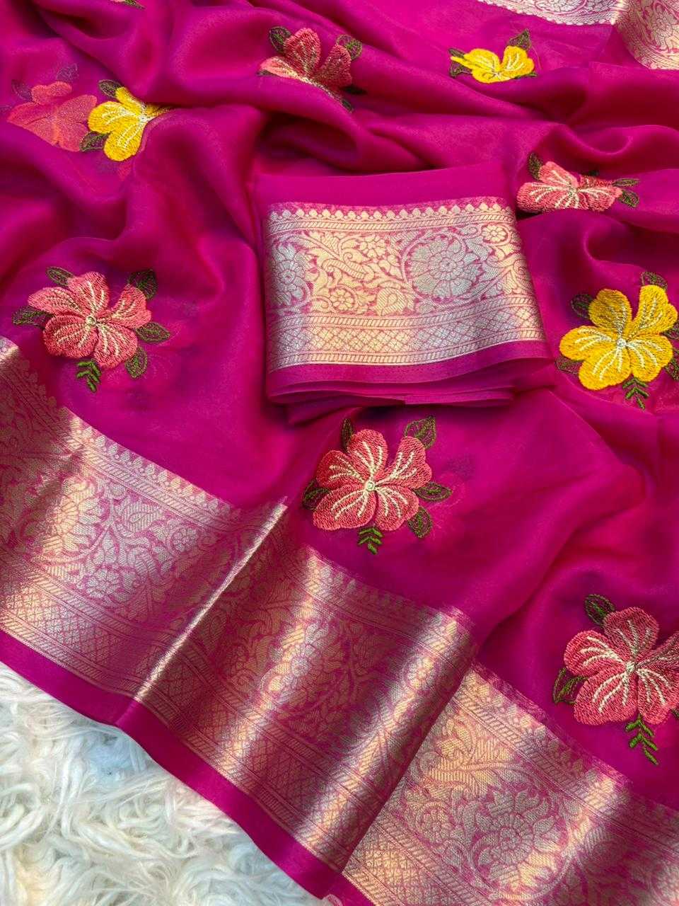 Pink saree with floral embroidery and a woven border on a white background