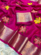 Pink saree with floral embroidery and a woven border on a white background