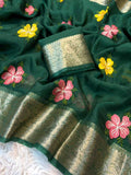 Green saree with floral embroidery and a white blouse