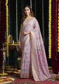 Woman in a light pink saree with a decorative background