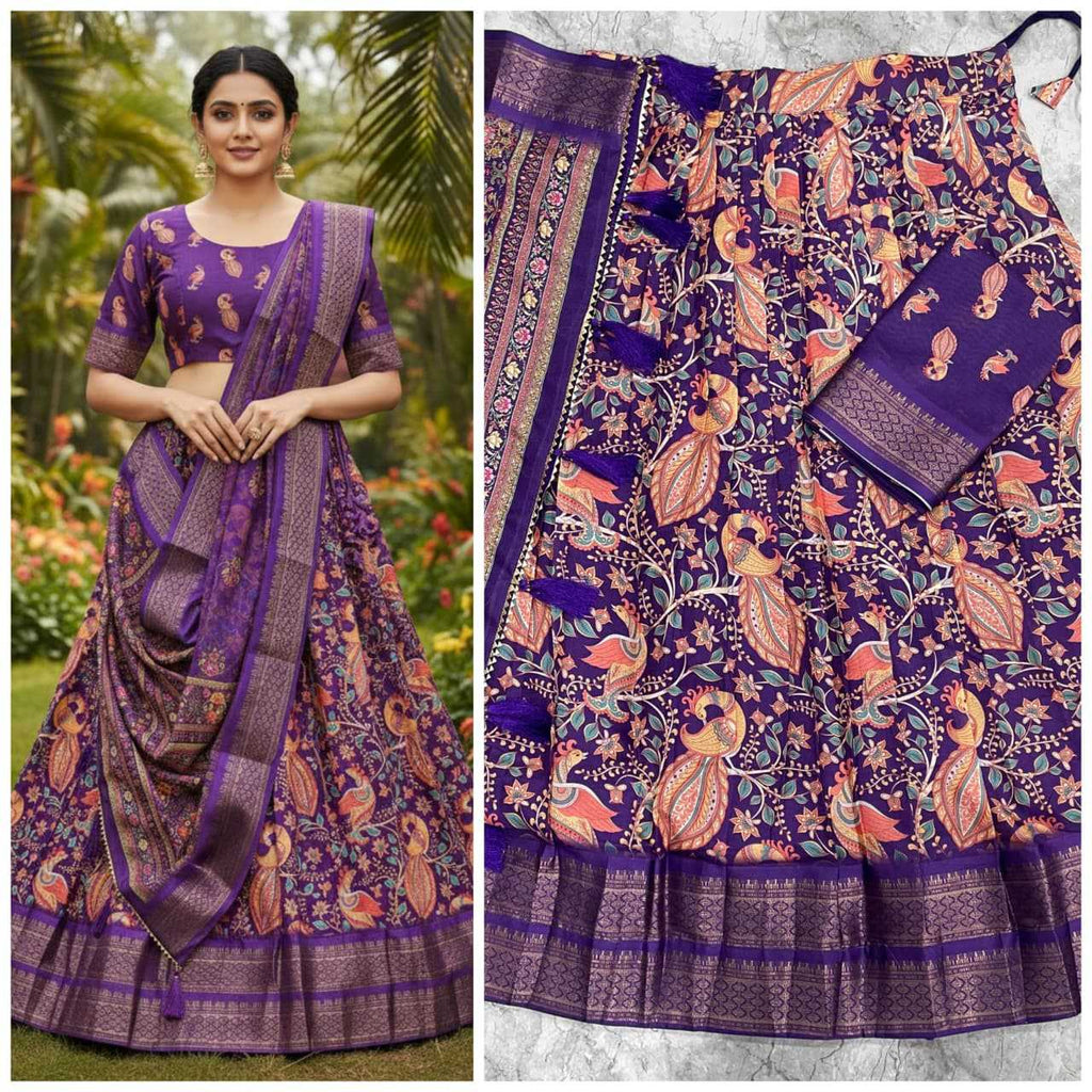 A purple and pink printed traditional Indian skirt set with a matching blouse, shown both worn by a model outdoors and laid flat. The fabric features intricate floral and peacock motifs with metallic zari borders.