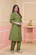 Woman wearing a green traditional outfit with a beige background