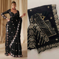 Black saree with gold embroidery worn by a model, close-up of saree details.